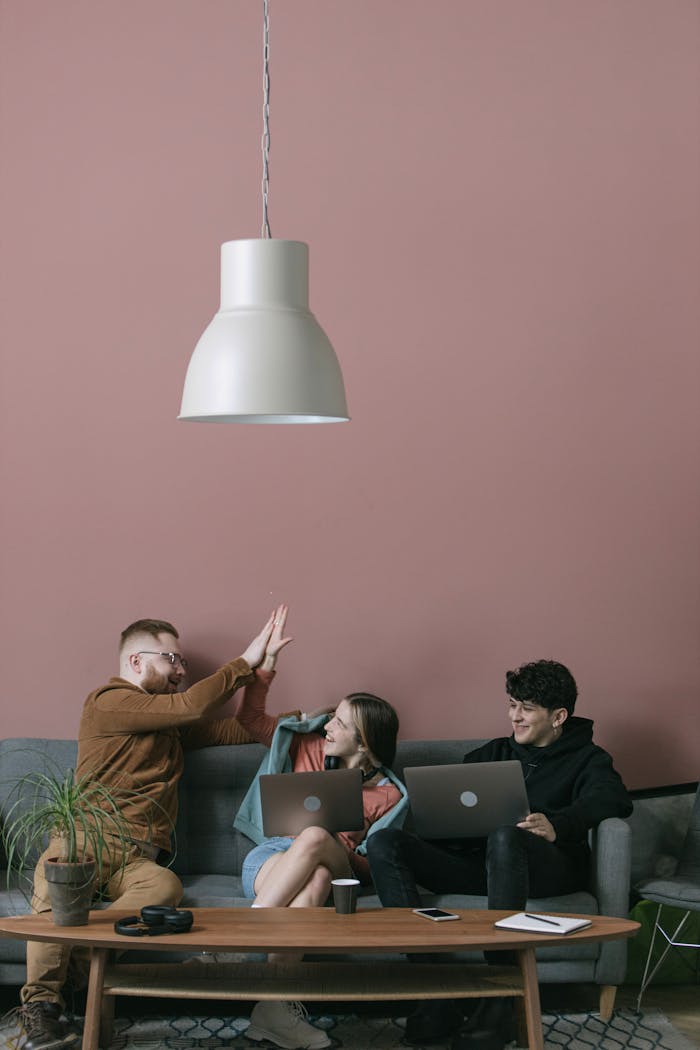 Three diverse team members collaborate in a stylish office setting.